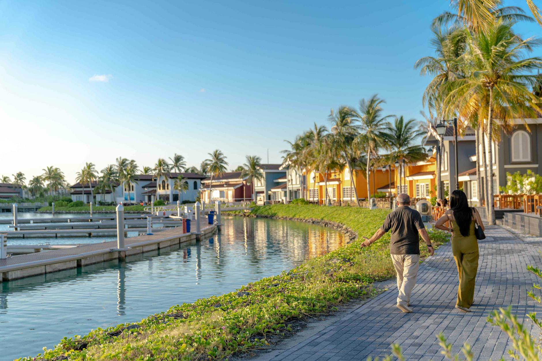 couple strolling along scenic marina pathway